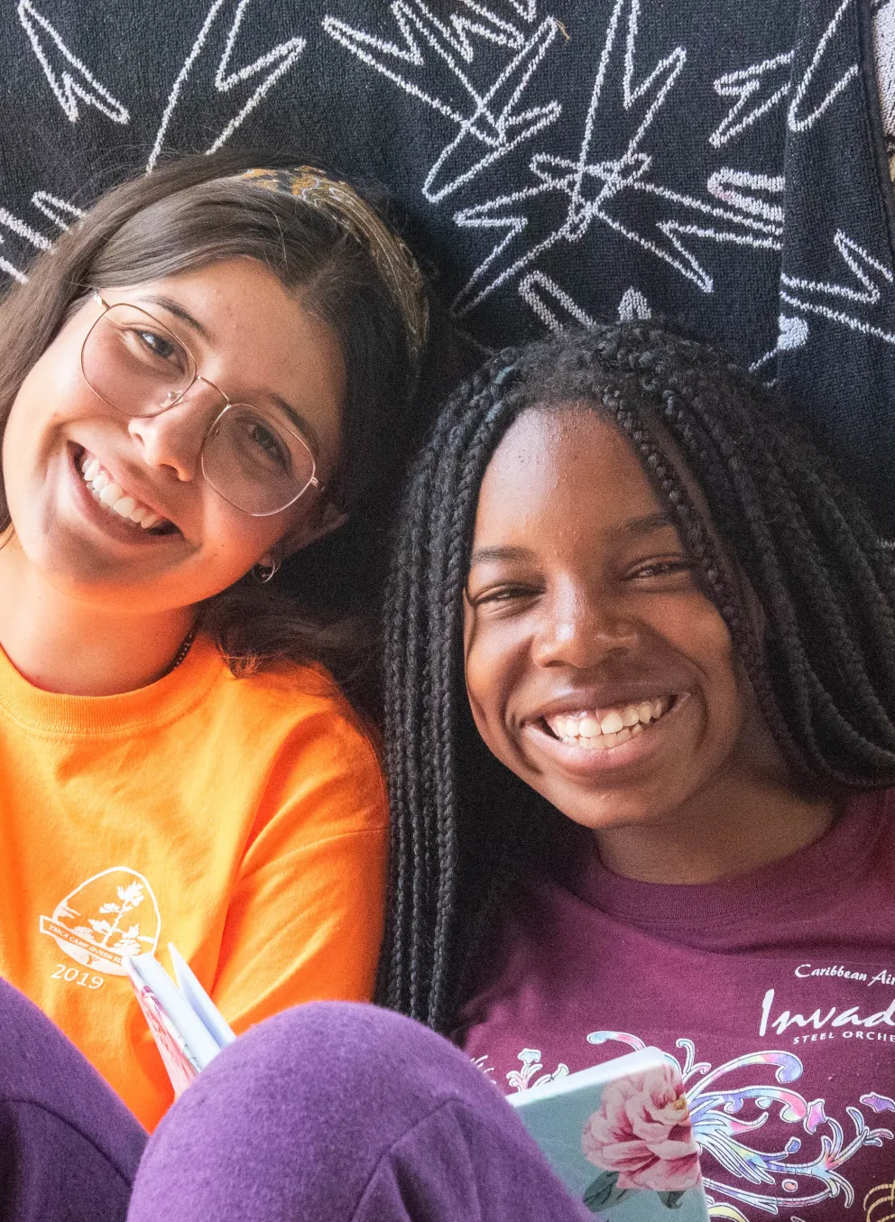 CQE Camp Counselor and Camper sitting on their cabin porch during free time.