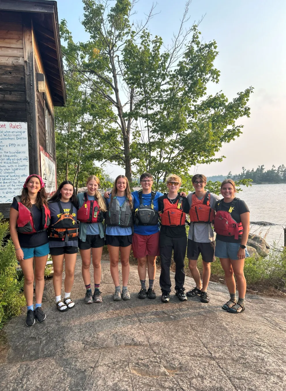 Youth standing together with life jackets on