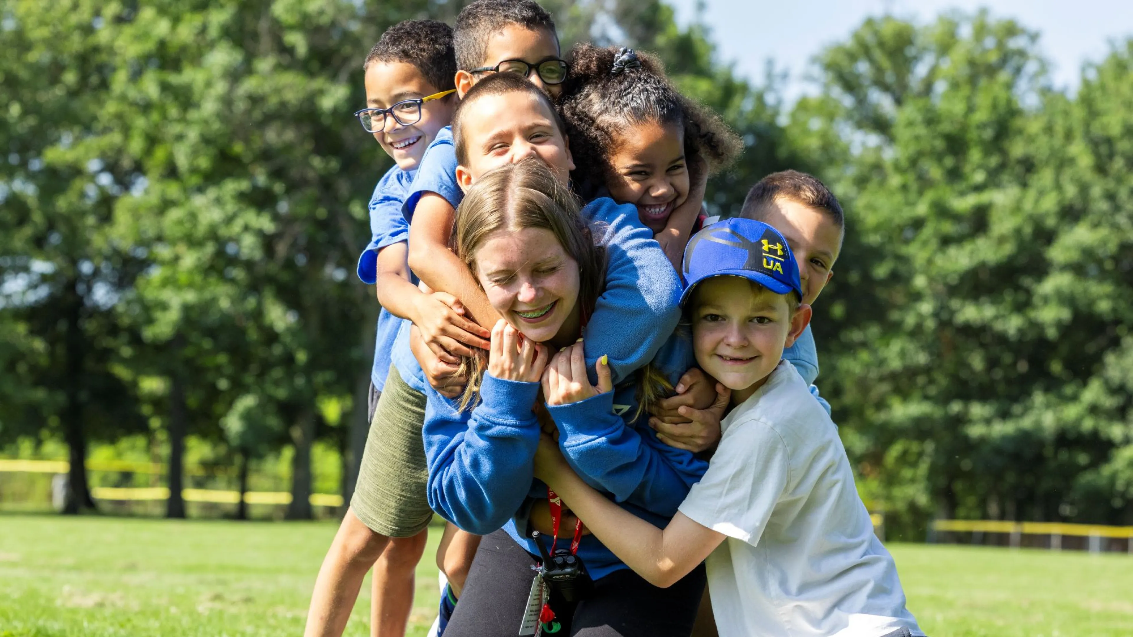 Kids hugging a counsellor at camp