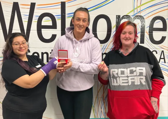 Representatives from 519Pursuit accept their 2022 YMCA Peace Medal.