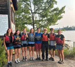 Youth standing together with life jackets on