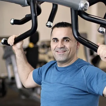 John performs upper body exercises at his local Y.