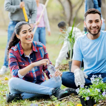 Man and Women helping plant a community garden