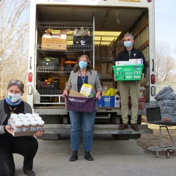 London Food Bank Co-Executive Director Jane Roy, South London Neighbourhood Resource Centre Executive Director Nancy Needham (centre), and YMCA Southwestern Ontario CEO Andrew Lockie outside the food bank's mobile food truck.