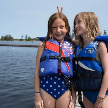 Two campers by lake having fun