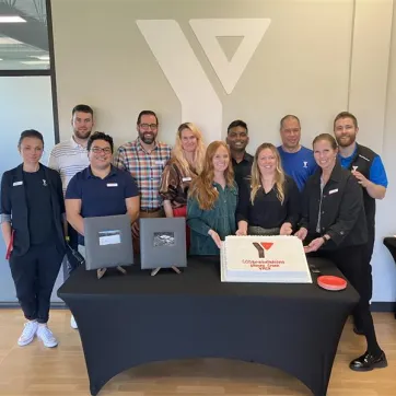 People celebrating around a cake