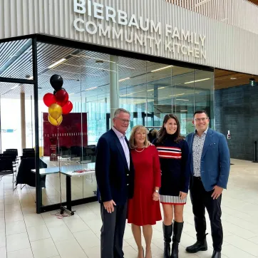 Bierbaum Family stands in front of Community Kitchen