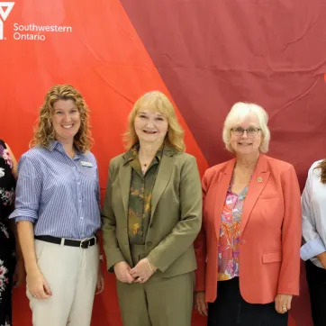 Five women infront of Y banner