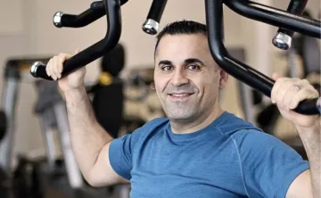 John performs upper body exercises at his local Y.